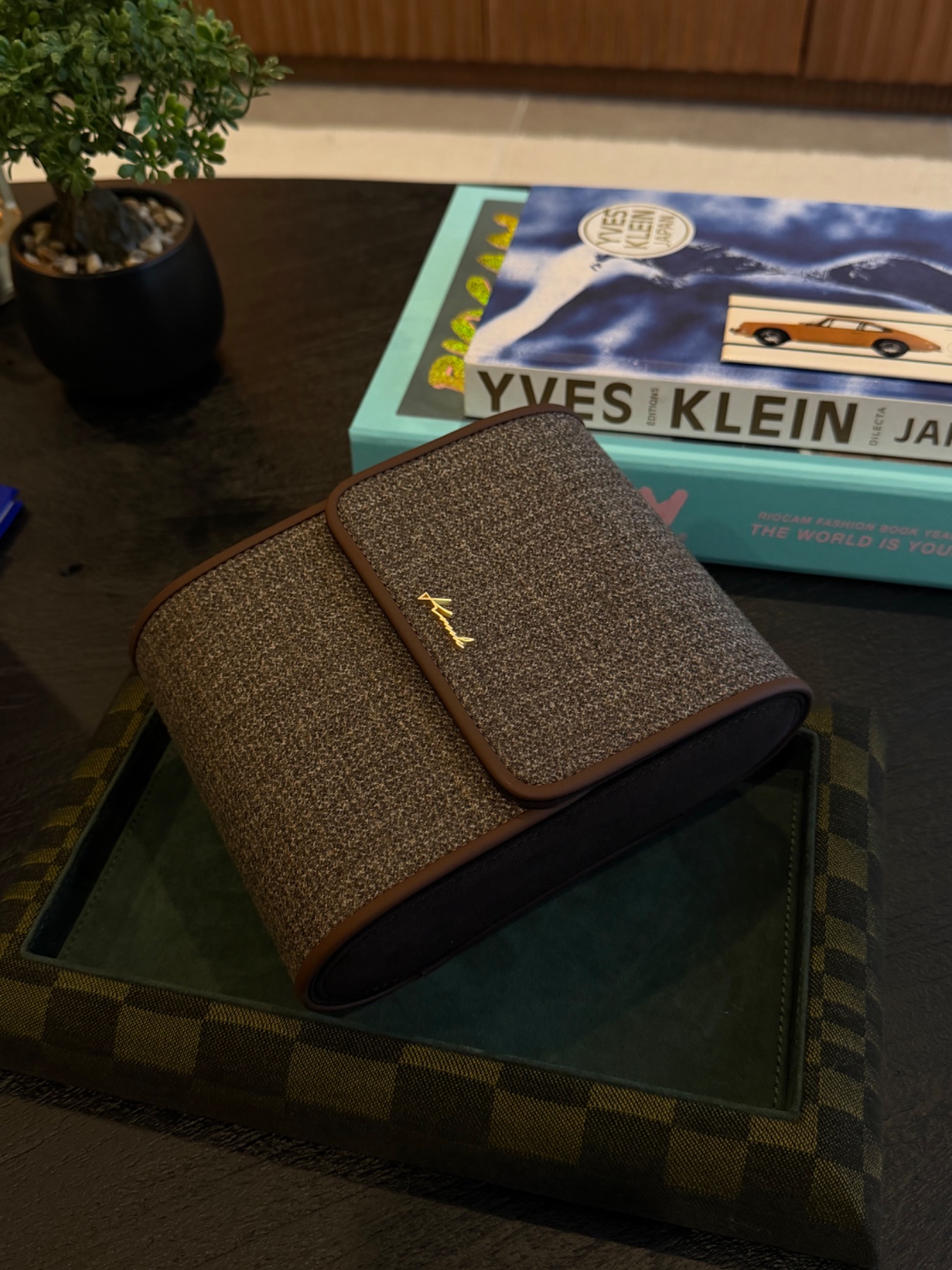 Kruk Designs houndstooth watch rolls, valet trays, and leather card holders on display, available through Dialed By H